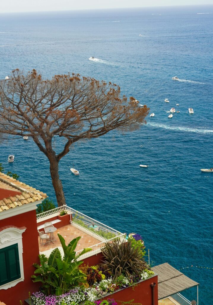 Stunning view of Positano coastline with azure waters and lush greenery.